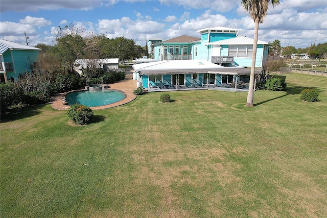 rear view of house with a balcony, a patio, and a lawn