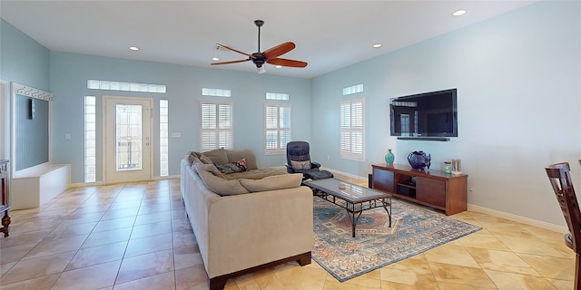 tiled living room featuring ceiling fan