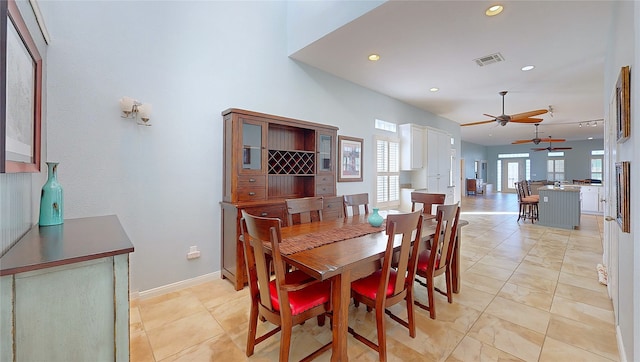 dining area with light tile patterned floors and ceiling fan