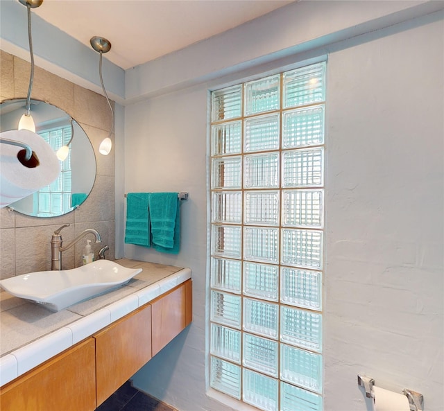 bathroom featuring vanity and backsplash