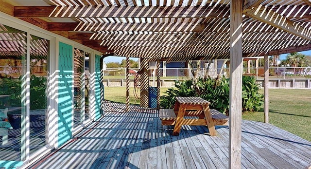 wooden deck featuring a pergola and a lawn