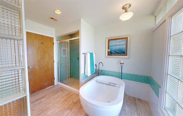 bathroom with hardwood / wood-style flooring and walk in shower