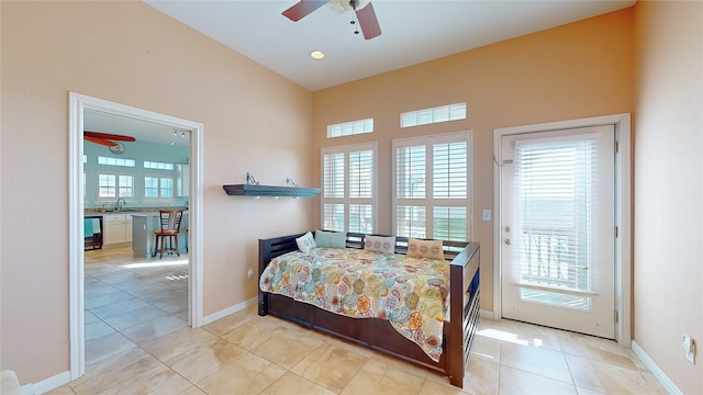 tiled bedroom featuring sink, multiple windows, and access to outside