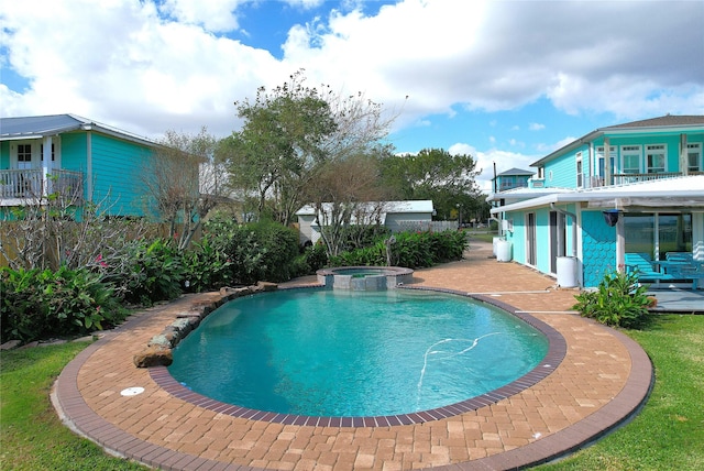 view of swimming pool featuring an in ground hot tub