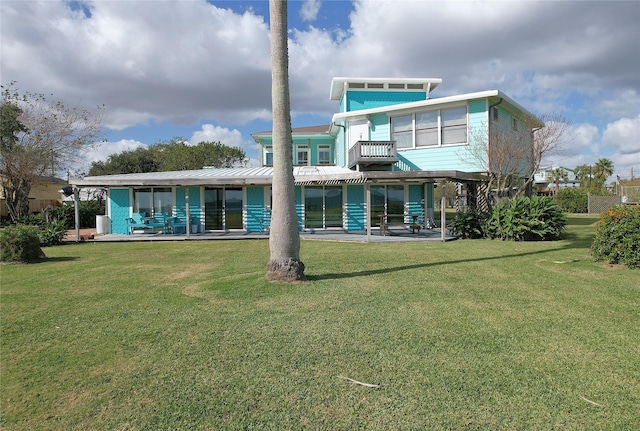 rear view of house featuring a yard