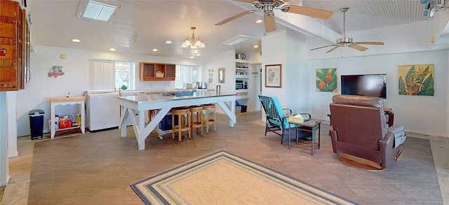 interior space featuring lofted ceiling and ceiling fan with notable chandelier