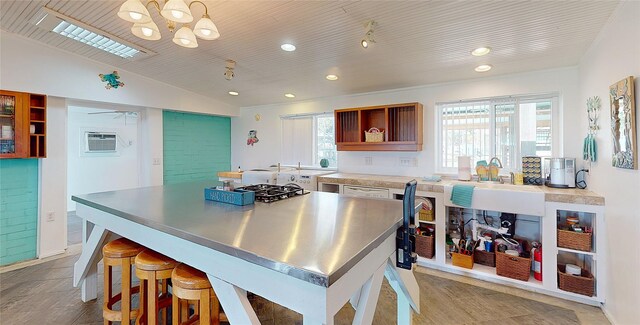 kitchen featuring vaulted ceiling, sink, a wall mounted AC, and white dishwasher