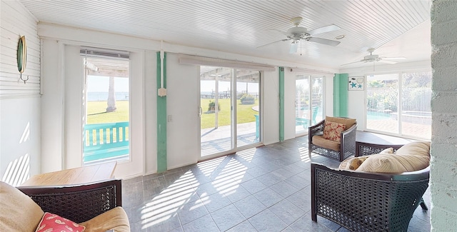 sunroom / solarium with plenty of natural light and ceiling fan