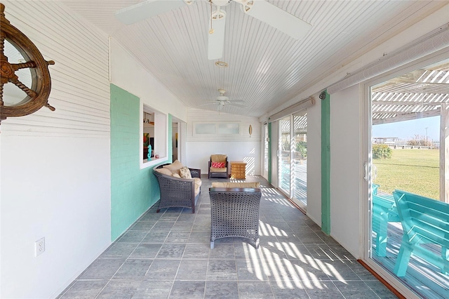 sunroom / solarium featuring ceiling fan