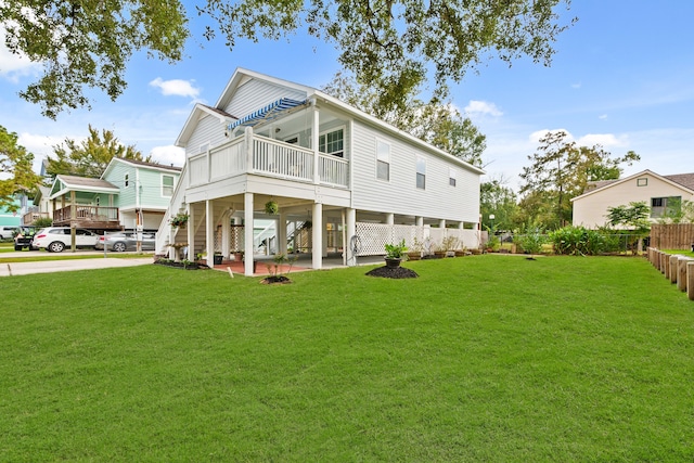 rear view of house featuring a carport and a yard