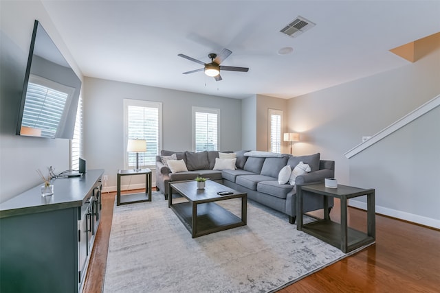 living room featuring hardwood / wood-style floors and ceiling fan