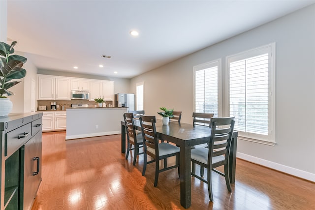 dining space featuring light wood-type flooring