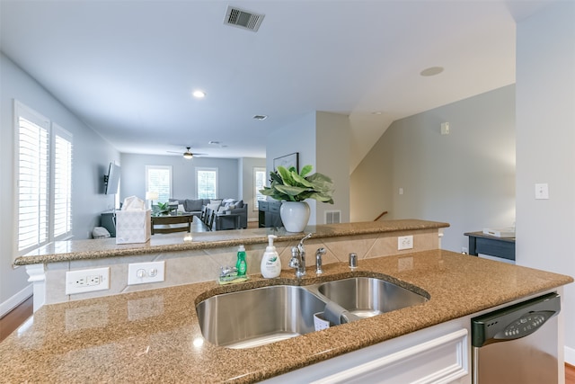 kitchen featuring stone counters, ceiling fan, sink, stainless steel dishwasher, and wood-type flooring