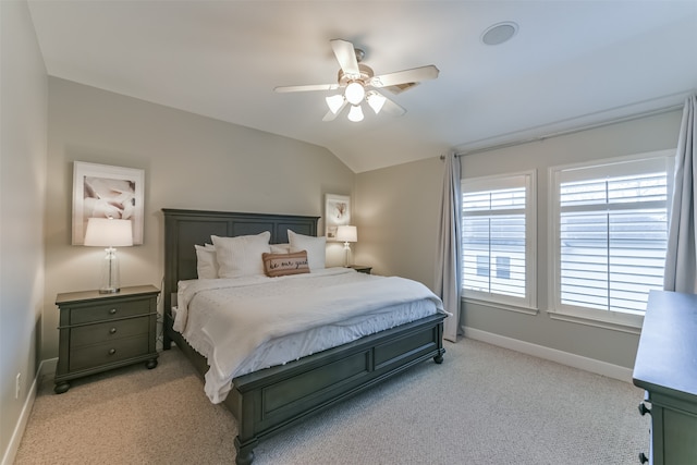 carpeted bedroom with ceiling fan and lofted ceiling