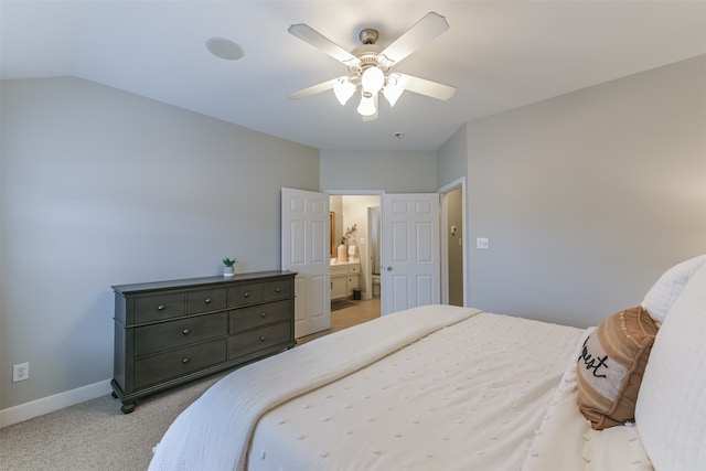 bedroom with light carpet, ensuite bathroom, ceiling fan, and lofted ceiling