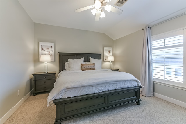 bedroom featuring ceiling fan, light colored carpet, and vaulted ceiling