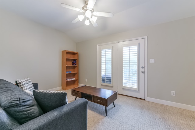 living room with ceiling fan, light carpet, and vaulted ceiling