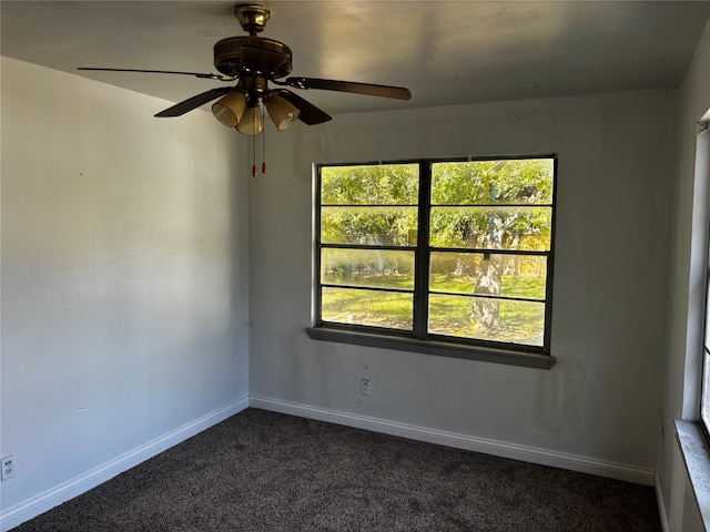 carpeted spare room featuring a wealth of natural light and ceiling fan