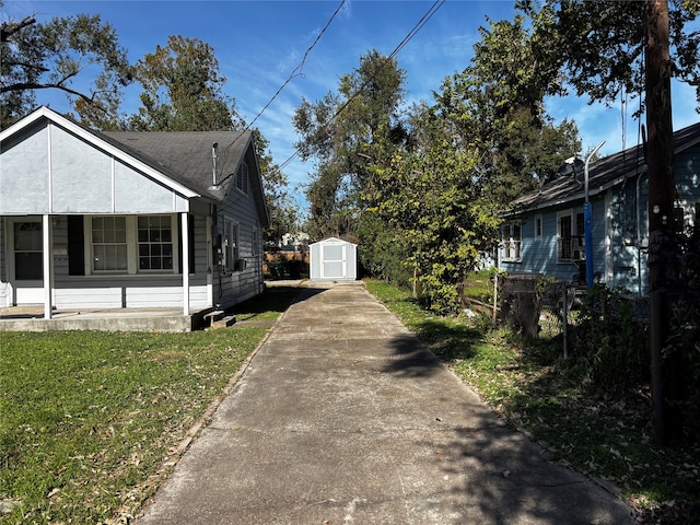 view of side of property with a porch, a storage unit, and a lawn