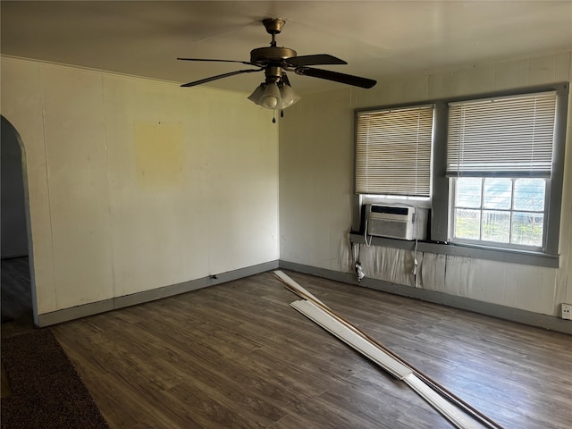 spare room featuring dark hardwood / wood-style floors, ceiling fan, and cooling unit