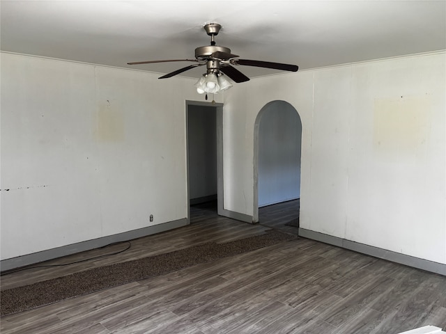 empty room with dark hardwood / wood-style flooring and ceiling fan