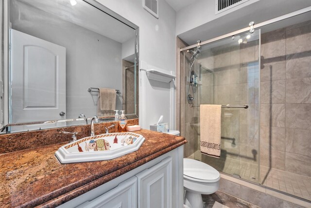 bathroom with vanity, toilet, and walk in shower