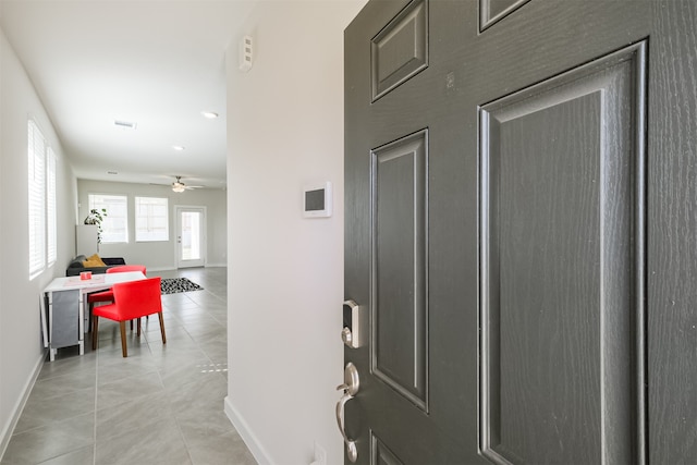 entryway featuring ceiling fan and light tile patterned floors