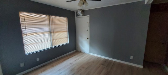 empty room with light wood-type flooring and ceiling fan