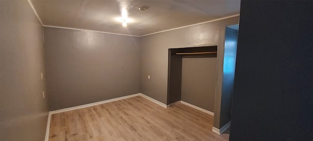 interior space featuring hardwood / wood-style flooring, a closet, and ornamental molding