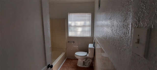 bathroom with tile patterned flooring and toilet