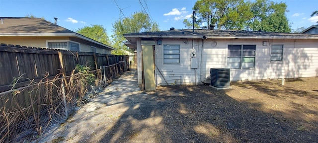 back of house with central AC