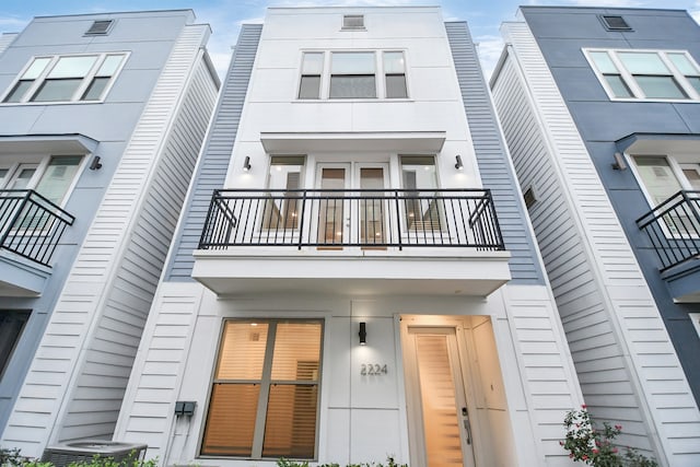 exterior space featuring central air condition unit and a balcony