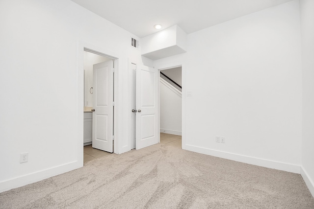 unfurnished bedroom with light colored carpet