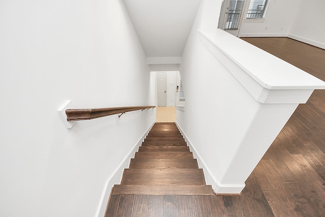 staircase with hardwood / wood-style flooring