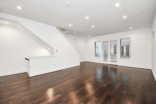 unfurnished living room featuring dark hardwood / wood-style floors