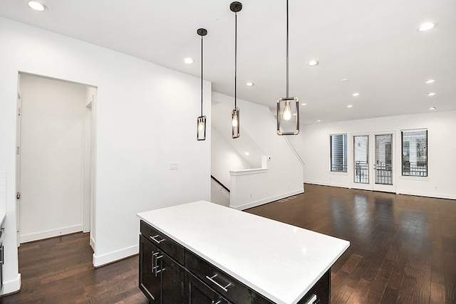 kitchen featuring pendant lighting, a kitchen island, and dark wood-type flooring