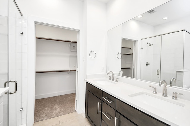 bathroom featuring vanity, tile patterned floors, and a shower with door