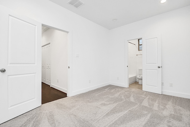 unfurnished bedroom featuring carpet flooring and a closet