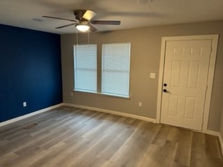 interior space featuring hardwood / wood-style floors and ceiling fan