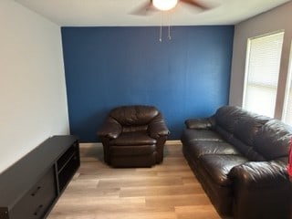 living room featuring ceiling fan and light wood-type flooring