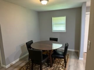 dining room with wood-type flooring