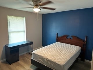 bedroom with ceiling fan and light hardwood / wood-style flooring