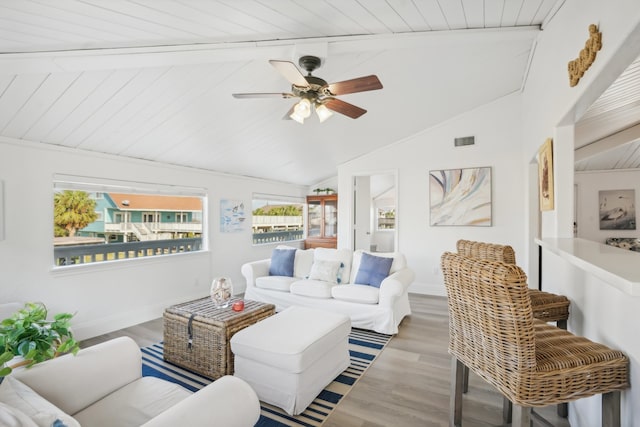 living room with wood ceiling, lofted ceiling with beams, ceiling fan, and wood-type flooring