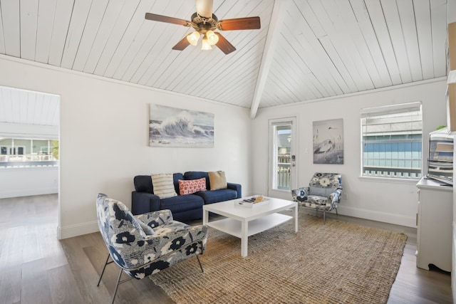 living room with hardwood / wood-style floors, plenty of natural light, ceiling fan, and vaulted ceiling with beams