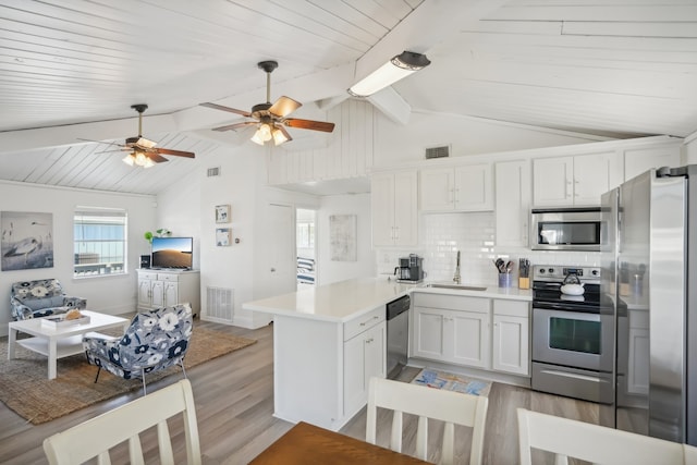 kitchen featuring white cabinetry, sink, ceiling fan, light hardwood / wood-style floors, and appliances with stainless steel finishes