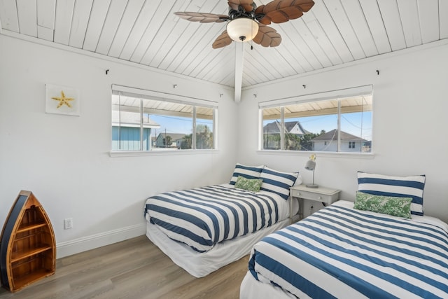 bedroom featuring ceiling fan, light hardwood / wood-style floors, and wooden ceiling