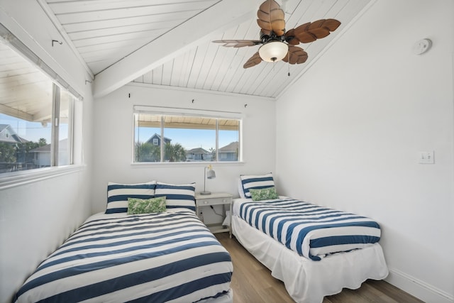 bedroom featuring vaulted ceiling with beams, dark hardwood / wood-style floors, ceiling fan, and wooden ceiling