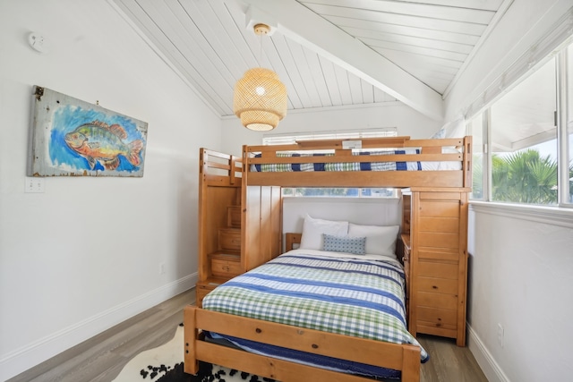 bedroom featuring wood ceiling, lofted ceiling with beams, and wood-type flooring