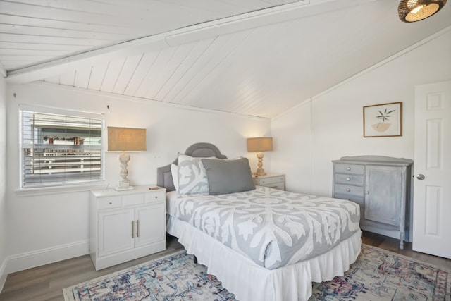 bedroom featuring hardwood / wood-style floors, vaulted ceiling with beams, and wood ceiling