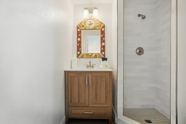 bathroom with vanity and tiled shower